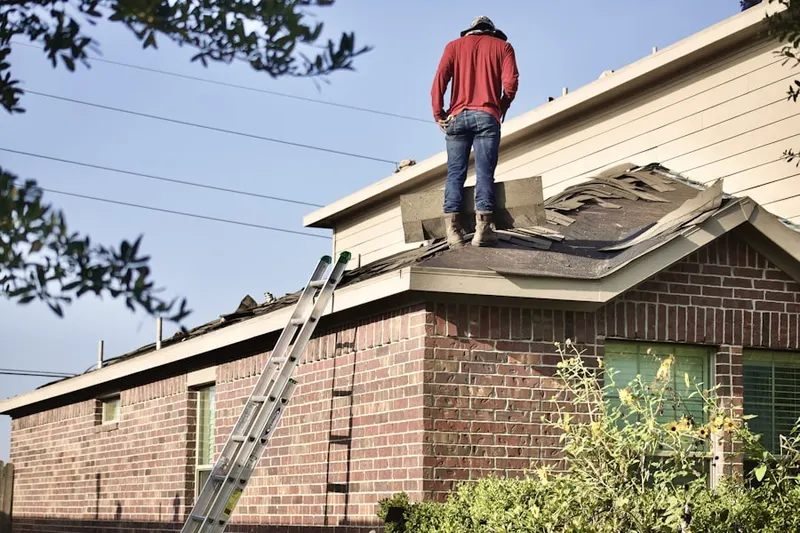 Professional roofer working on a residential roof in Potomac Village
